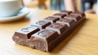 Euro Symbol Embossed Chocolate Bar On Wooden Table