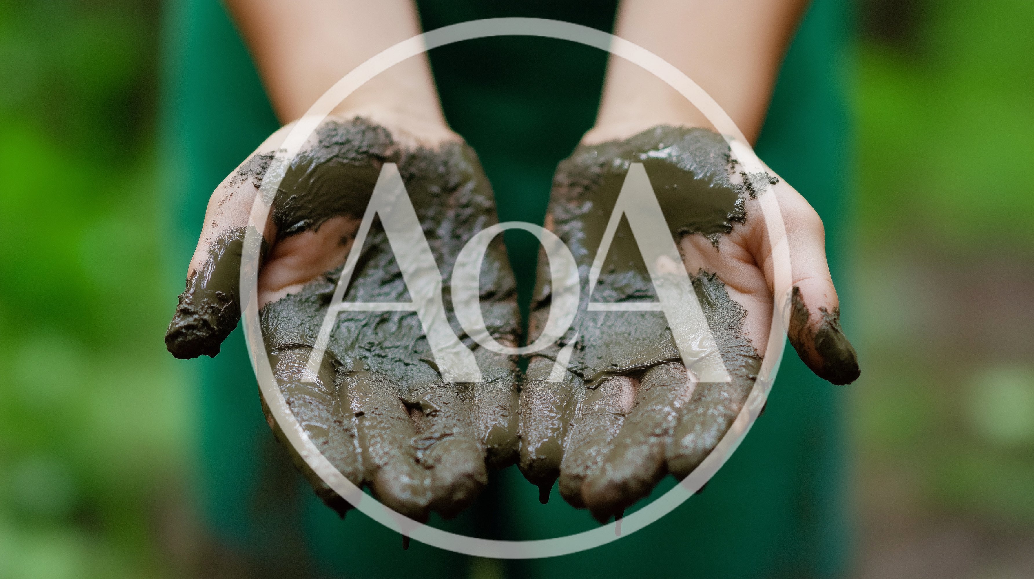 Person Holding Wet Mud In Cupped Hands
