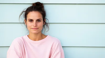 Portrait Of A Young Woman Against A Blue Wall