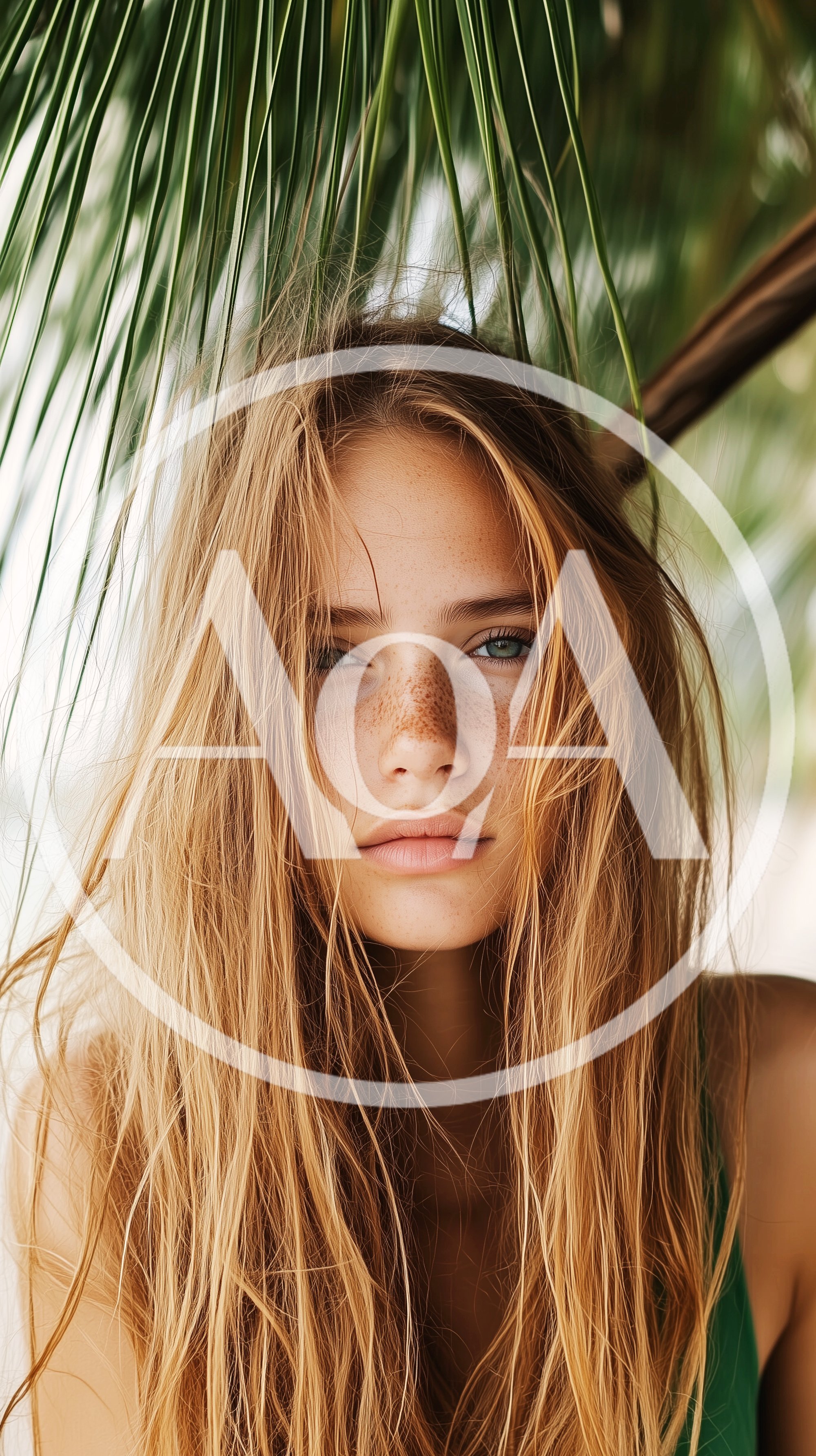Portrait Of A Young Woman With Freckles Under Palm Leaves