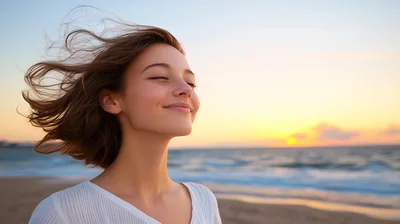 Young Woman Enjoying Ocean Breeze at Sunset