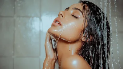 Young Woman Washing Face Under Shower