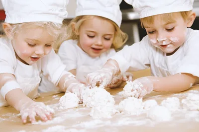 Three Toddlers Playing With Flour In Chef Hats
