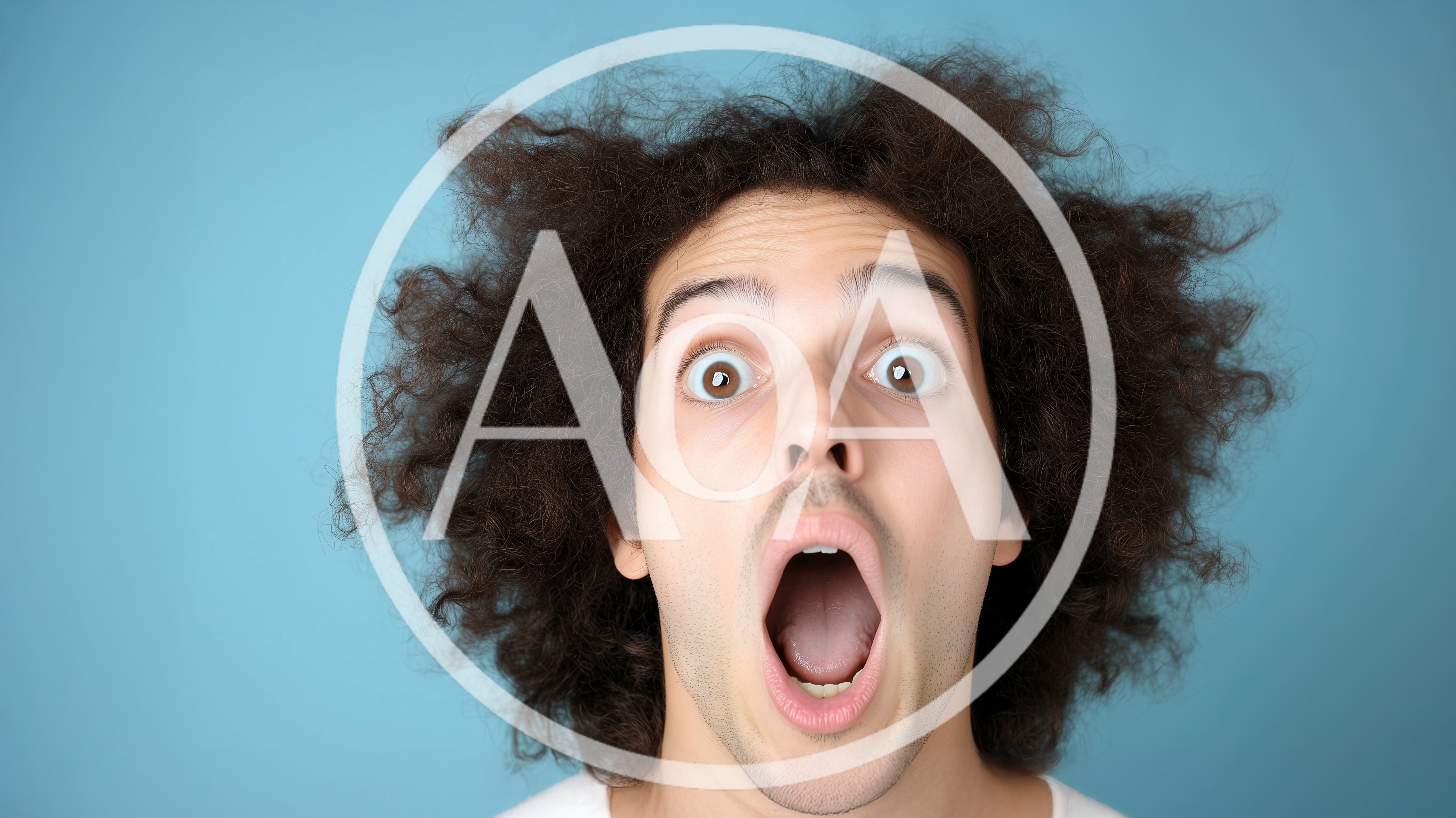 Surprised Young Man With Curly Hair Looking At Camera