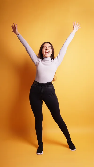 Happy Young Woman Celebrating With Arms Raised