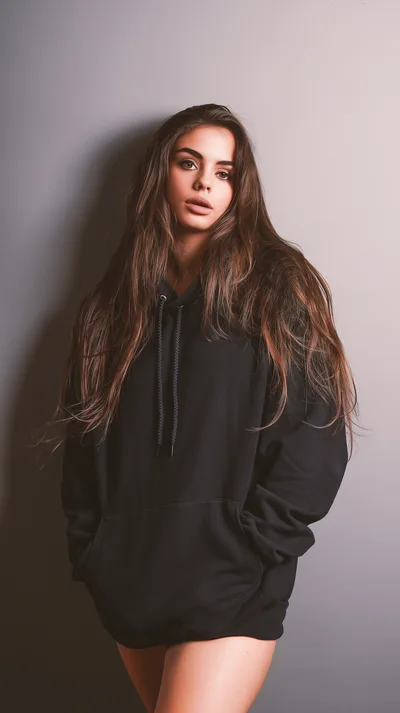 Young Woman Posing In A Black Oversized Hoodie