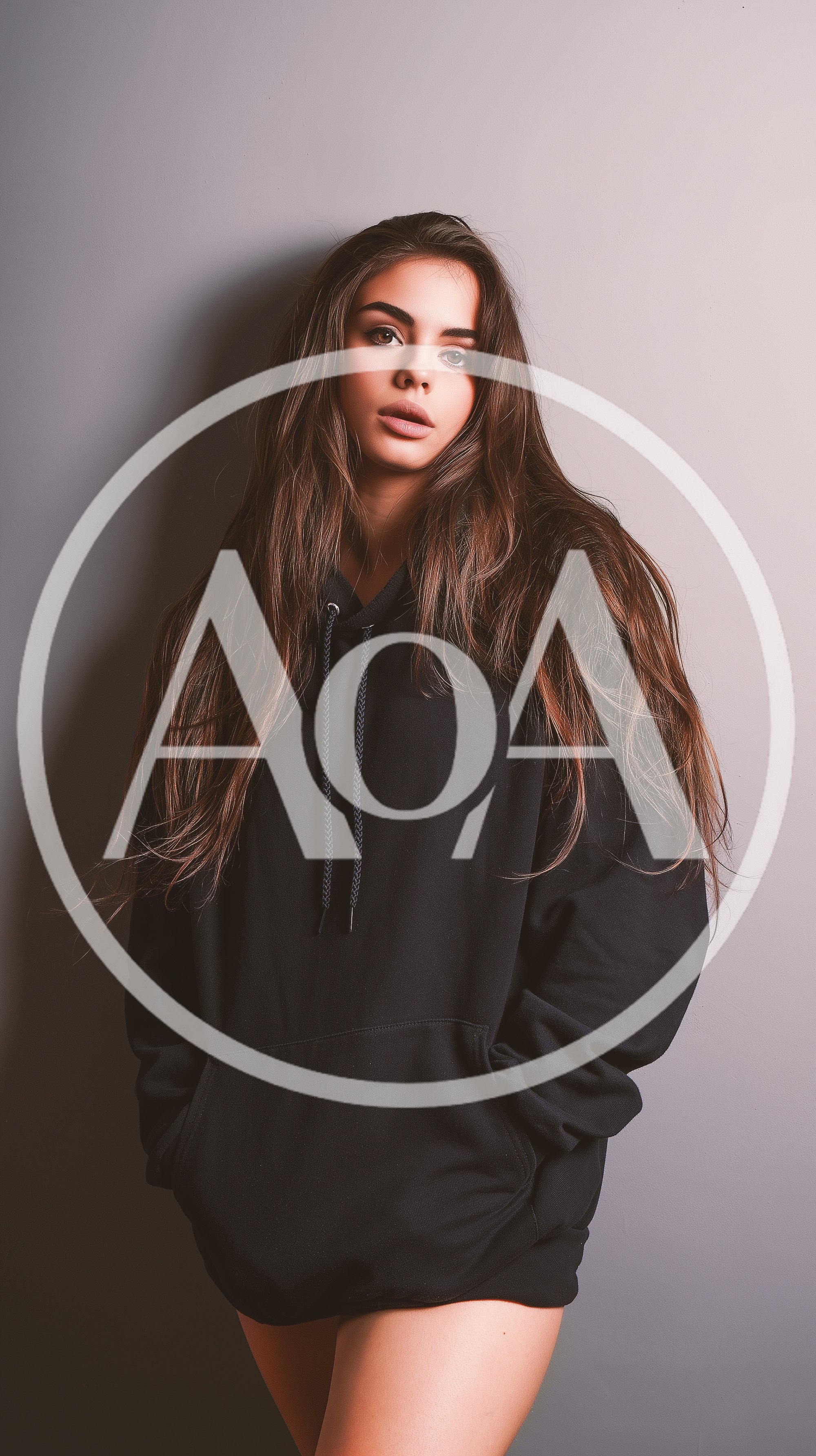 Young Woman Posing In A Black Oversized Hoodie