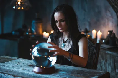 Young Woman Gazing Into A Glowing Crystal Ball