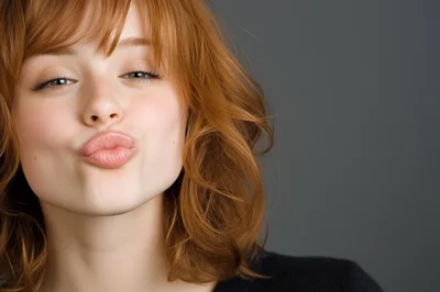 Young Woman With Red Hair Pouting Lips