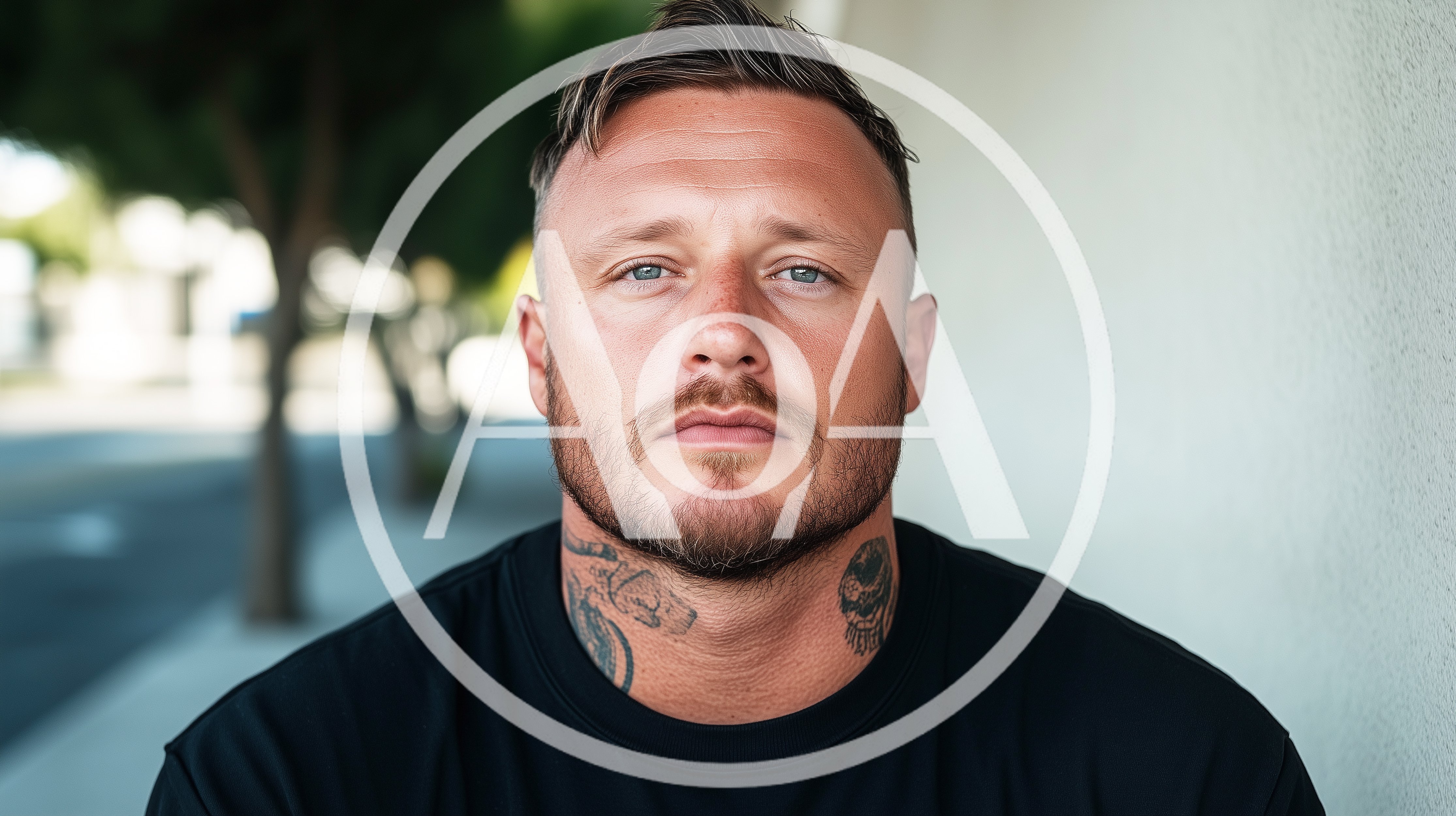 Portrait Of A Man With Neck Tattoos