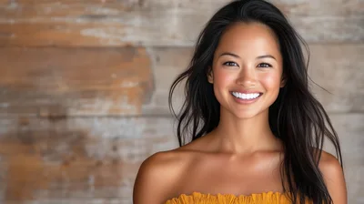 Portrait Of A Smiling Young Woman With Long Dark Hair