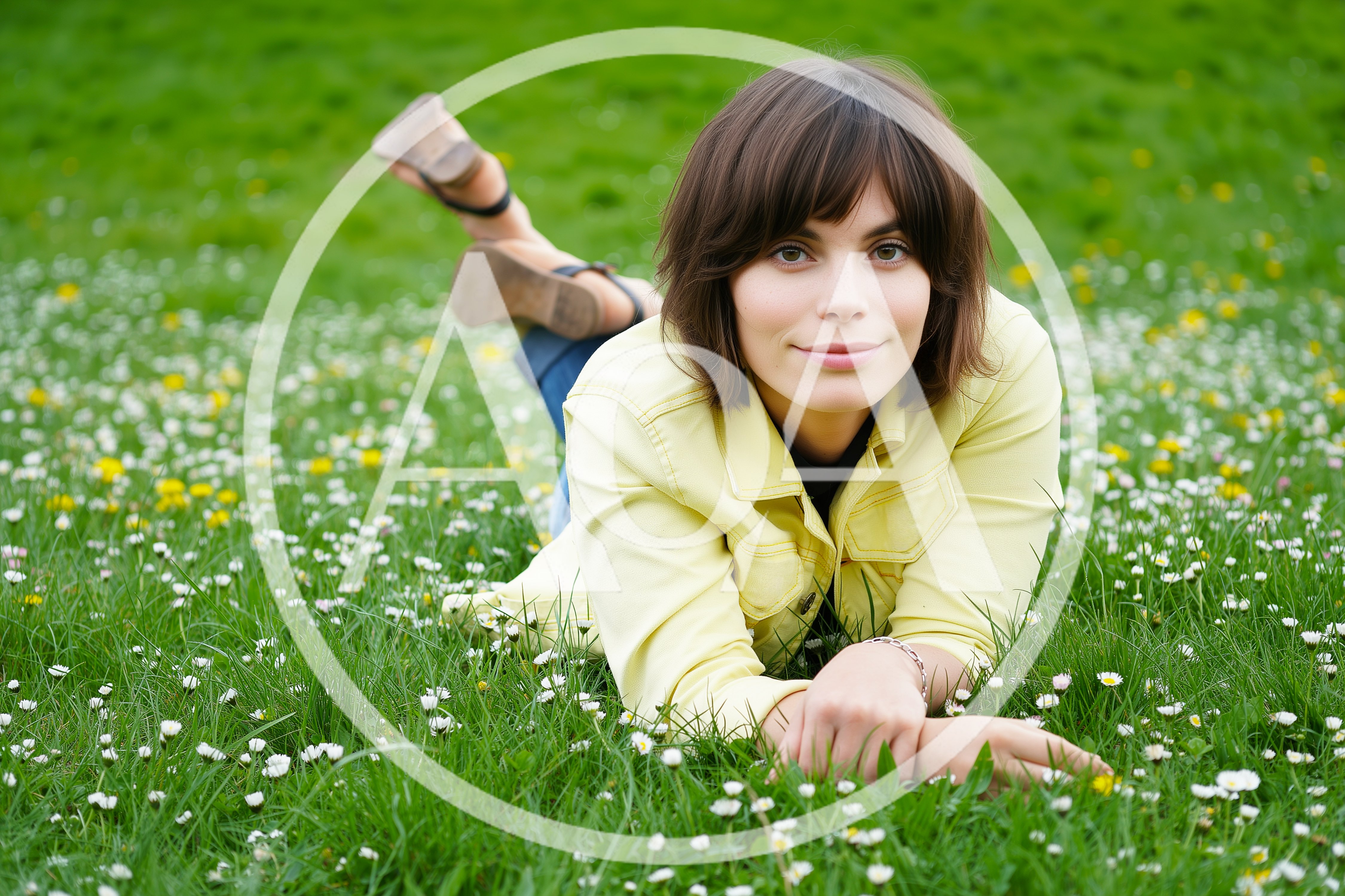 Young Woman Relaxing In A Meadow Of Daisies