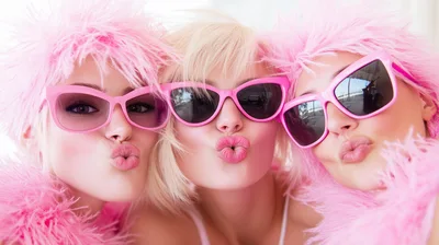 Three Young Women Posing With Pink Feather Boas