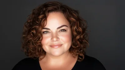 Portrait Of A Smiling Woman With Curly Hair