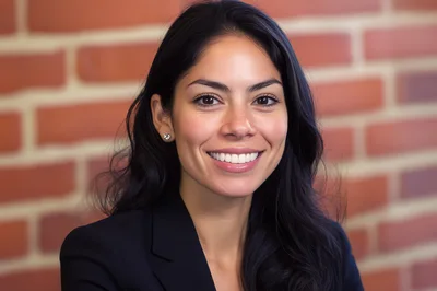 Professional Woman Smiling In Front Of Brick Wall