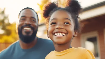 Happy Father and Daughter Smiling Outdoors