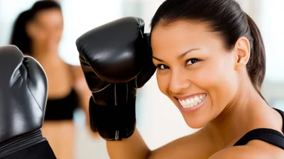 Smiling Woman Wearing Boxing Gloves In A Gym
