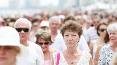 Crowd Of People Walking Outdoors On A Sunny Day