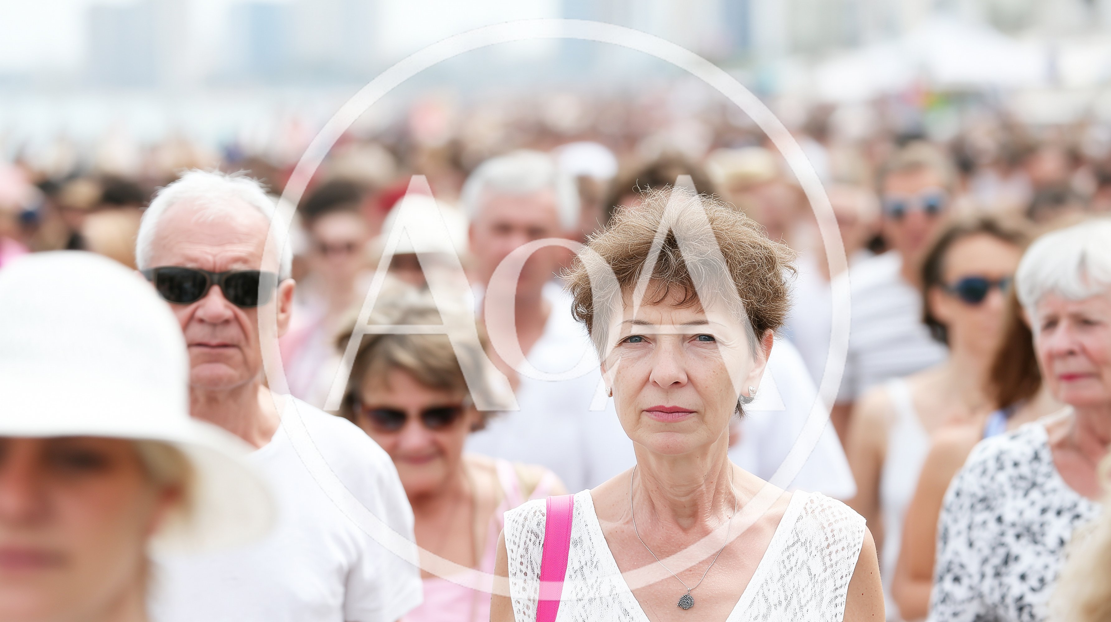 Crowd Of People Walking Outdoors On A Sunny Day