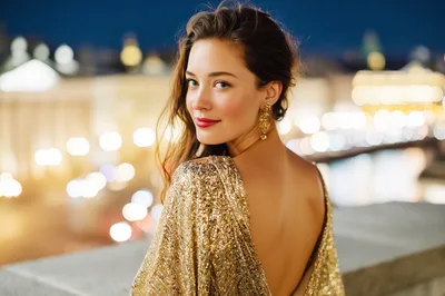 Elegant Woman In Gold Sequin Dress At Night