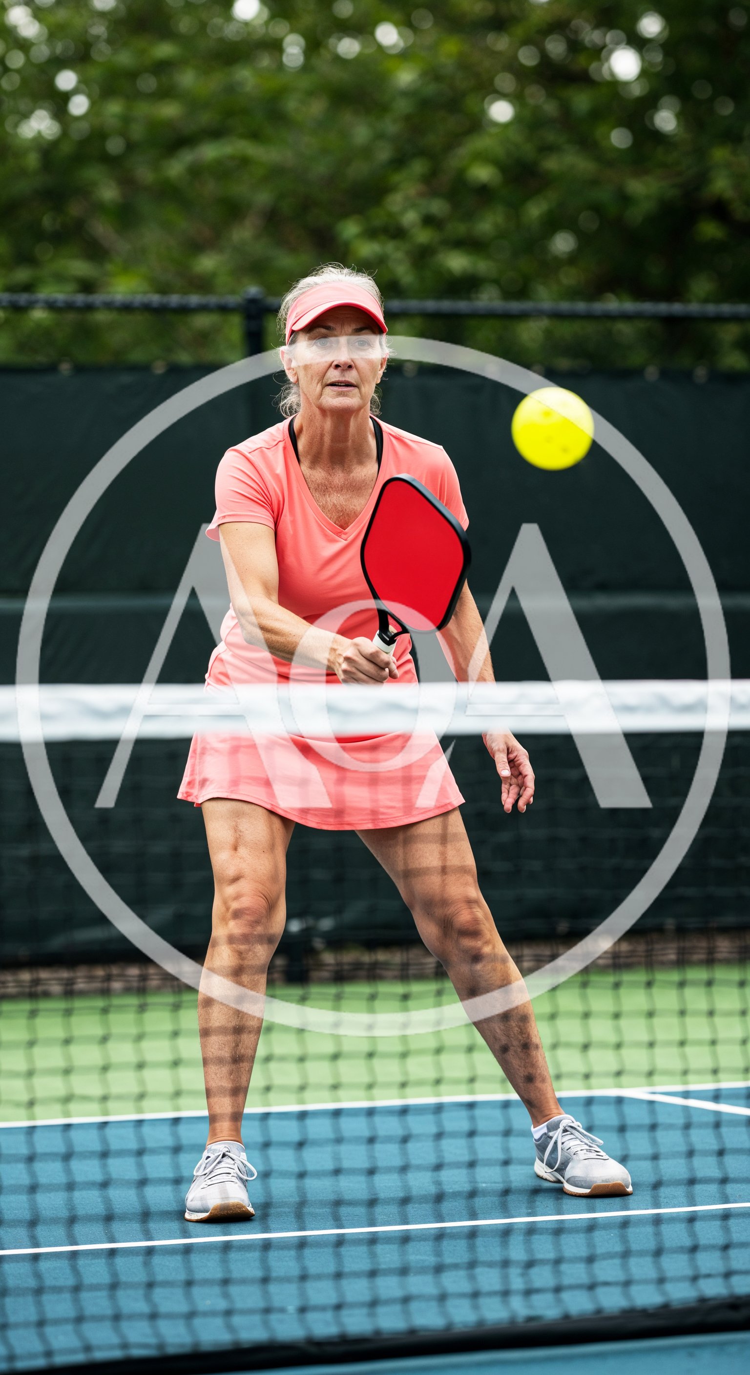 Mature Woman Playing Pickleball on Outdoor Court