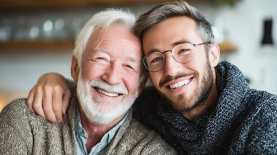 Portrait Of A Smiling Senior Man And His Adult Son
