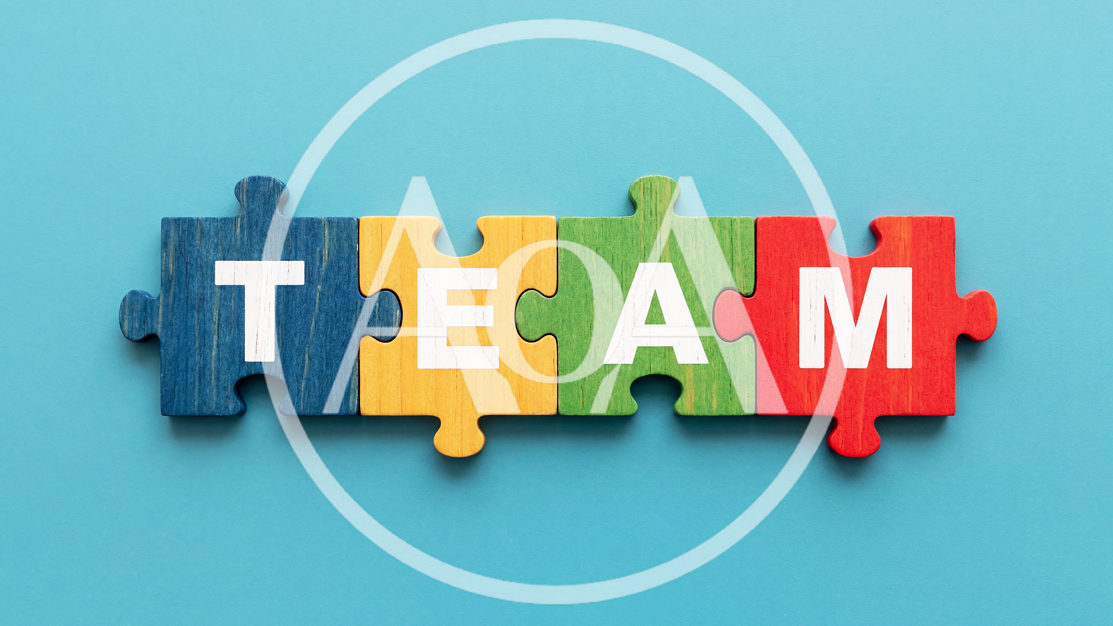 Four Colorful Puzzle Pieces Forming The Word Team