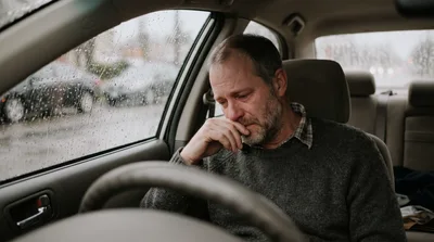 Sad Middle Aged Man Crying Inside A Car