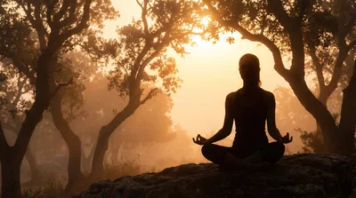 Woman Meditating In Lotus Position At Sunrise