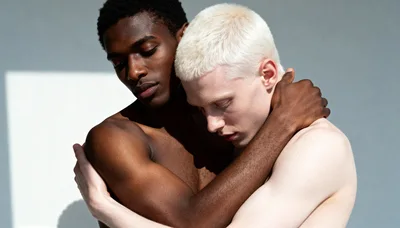 Two Men Embracing Against A Minimalist Background