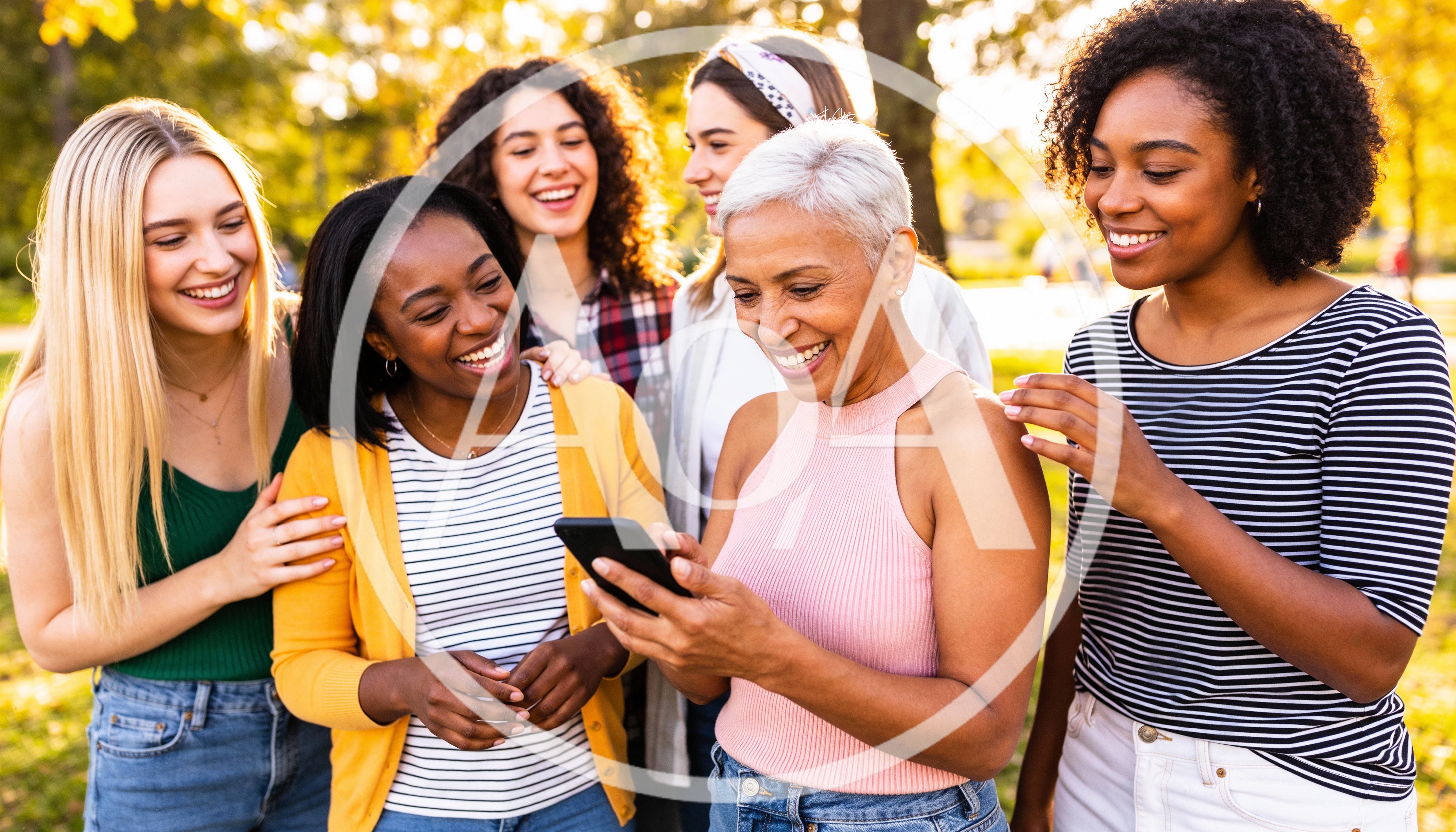 Diverse Group of Women Looking at Smartphone Outdoors