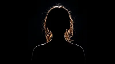 Silhouette Of A Woman Against A Dark Background
