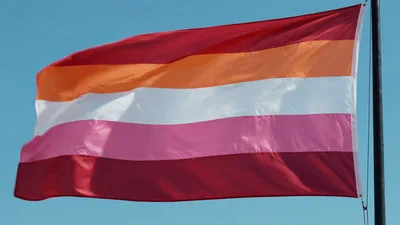 Lesbian Pride Flag Waving Against Blue Sky