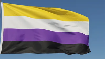 Non-Binary Pride Flag Waving Against Blue Sky
