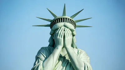 Statue Of Liberty Covering Face In Disappointment