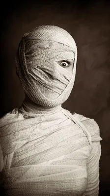 Mummy Wrapped In Gauze Bandages Looking With One Eye