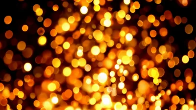 Golden Bokeh Light Particles Floating On Black Background