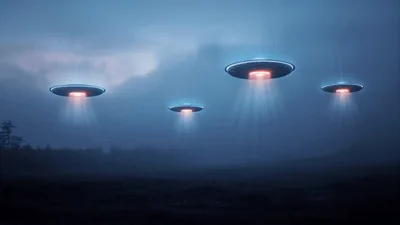Four Flying Saucers Hovering Over A Dark Landscape