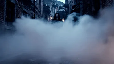 Mysterious Figure Walking Through Thick Fog In Dark Alley