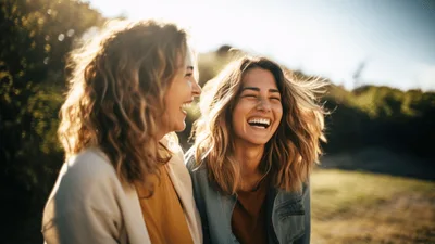 Two Happy Women Laughing Together Outdoors