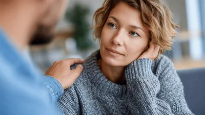 Supportive Man Comforting A Woman During A Conversation