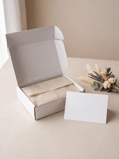 Open White Shipping Box With Blank Greeting Card