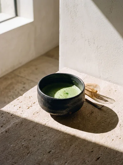 Matcha Tea in a Ceramic Bowl with Bamboo Whisk