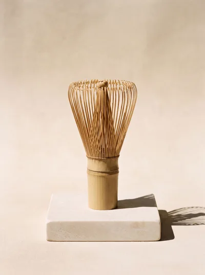 Bamboo Matcha Whisk On A Stone Pedestal