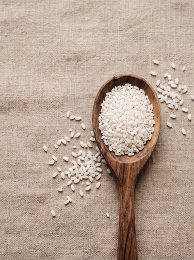 Wooden Spoon Filled With Raw White Rice