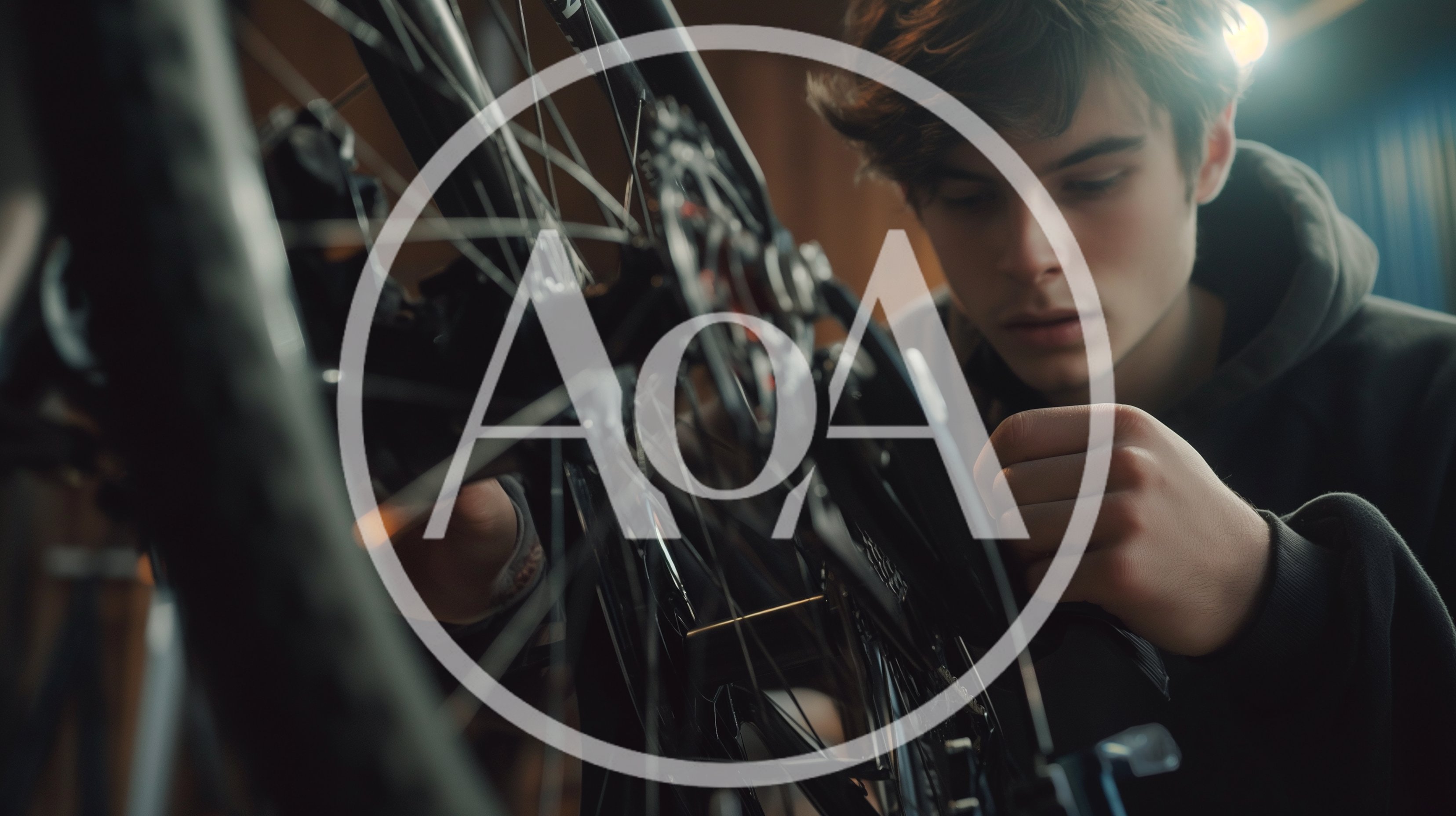 Young Man Repairing Bicycle In Workshop