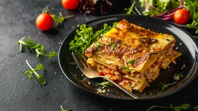 Freshly Baked Lasagna Served on a Black Plate