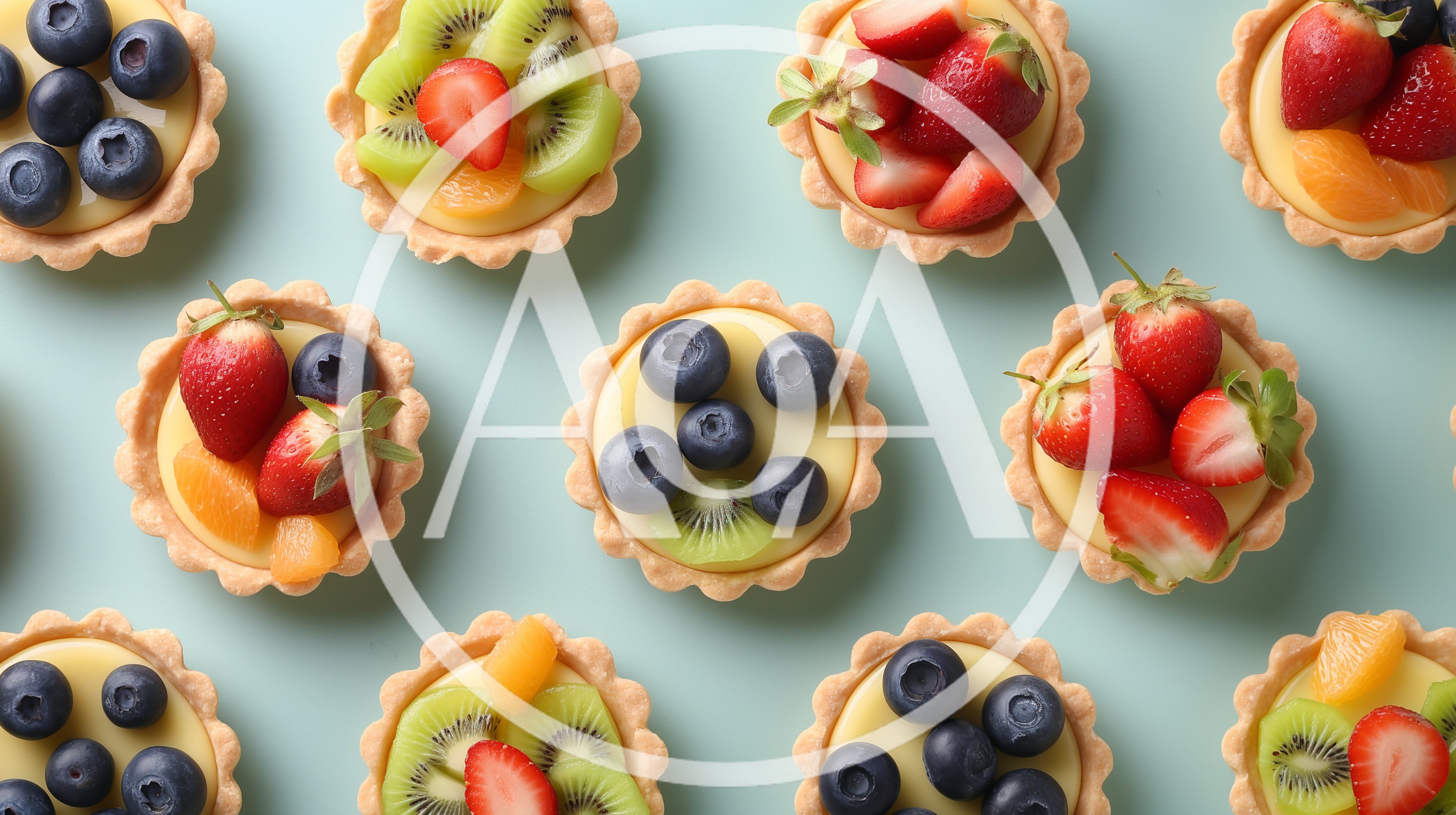 Assorted Fruit Tarts Arranged on Light Blue Background