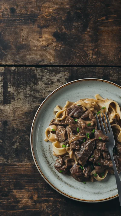Beef Stroganoff With Egg Noodles On A Rustic Table