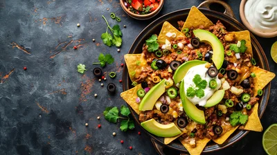 Plate Of Loaded Nachos With Avocado And Sour Cream